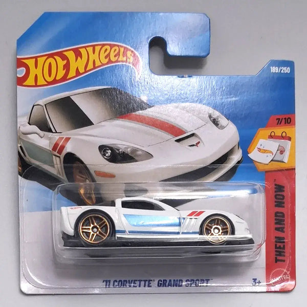 Hot Wheels 'T'Corvette' Grand Sport die-cast toy car in its original blister card packaging, featuring a white Corvette design with red and light blue stripes.