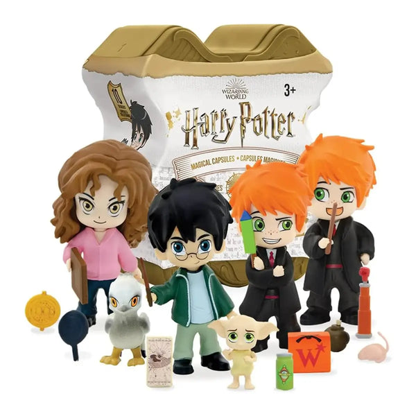 A set of Harry Potter character figurines and accessories displayed in front of their collectible capsule packaging. The figures include characters in black robes, a figure in a pink top, a figure in a green jacket, and a small white creature, along with themed accessories like a cauldron, wand, and potion bottles.