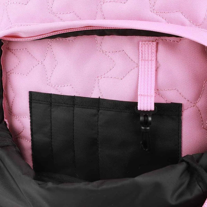 Close-up of a pink quilted bag with a black pocket