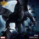 Marvel Midnight Suns One:12 collectible figure of Killmonger, shown in a dynamic crouching pose with knives in his hands against a backdrop of a large full moon and flying bats. The image includes branding for Marvel, Midnight Suns, and Mezco Toyz.