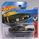 Hot Wheels '68 Shelby GT500 die-cast toy car in its original blister card packaging, featuring an olive green body with yellow and white racing stripes.