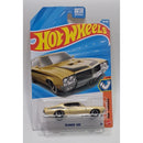 A Hot Wheels '70 Buick GSX die-cast toy car in its original blister card packaging, featuring a gold car with black racing stripes on a blue and red card.