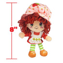 Plush toy with red hair and a pink hat, standing next to a 8-inch measurement stick on a white background.