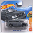 A Hot Wheels die-cast toy car of a '94 Audi Avant RS2, presented in its original blister pack on a blue and orange card. The toy car is dark gray, and the packaging features the Hot Wheels logo.