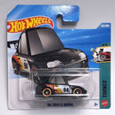 Hot Wheels Tooned '94 Toyota Supra die-cast toy car in its original blister card packaging, featuring a black race car with orange and white decals.