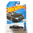 A Hot Wheels '98 Honda Prelude die-cast toy car in its original blister card packaging, featuring a black car with silver wheels on a blue and white card.