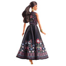 Barbie doll wearing a floral dress on a white background
