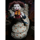 Krampus Der Clown Deluxe NECA 7 Inch Scale Action Figure, pictured with shoes in mouth