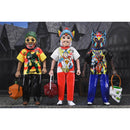 Three colorful Halloween costume figures with masks in front of a house.