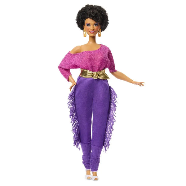 Barbie doll wearing a pink top and purple pants with a gold belt on a white background
