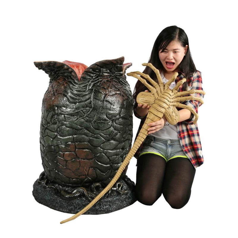 NECA Life-sized Light-Up Alien Xenomorph Egg with Facehugger, showing girl holding facehugger next to egg