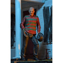 Horror character Freddy in a striped sweater holding an axe and hat in a dimly lit setting