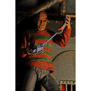 Freddy action figure in a red and green striped sweater holding a tool, with a dark background.