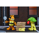 Garfield and Odie cartoon character figurines in front of a brick wall.