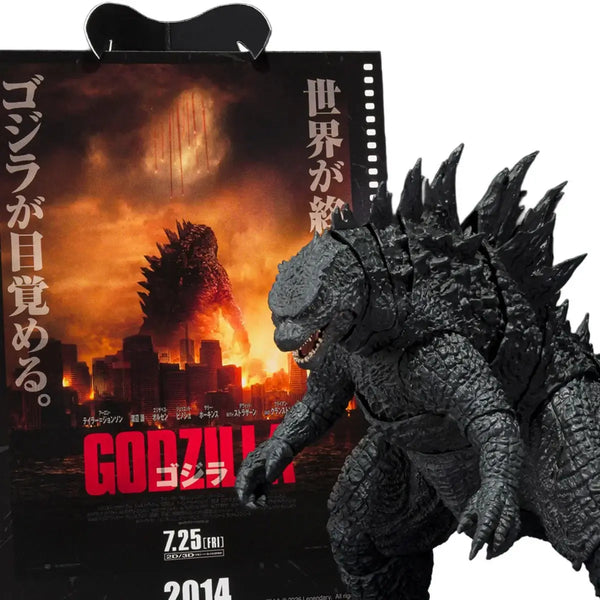 Godzilla action figure in front of a movie poster for Godzilla