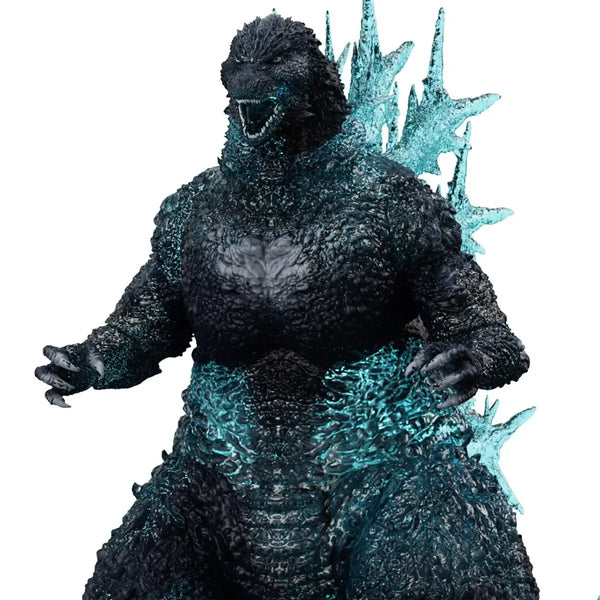 Godzilla toy figure with blue energy effects on a white background
