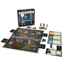Board game set up with components including a board, cards, and pieces on a white background