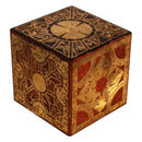 An ornate square wooden box with intricate gold and red geometric patterns