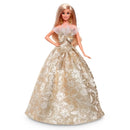 Barbie doll in a gold and white gown on a white background