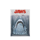 Packaged toy shark with 'JAWS' branding on a white background