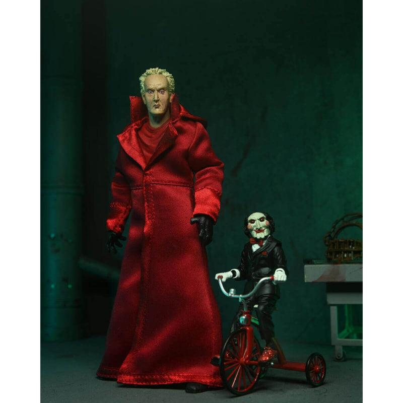 Saw Ultimate Jigsaw with Red Robe 7 Inch Scale NECA Action Figure pictured with Billy the puppet on his tricycle