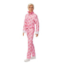 Barbie the movie Ken doll wearing pink pajamas with a pattern on a white background