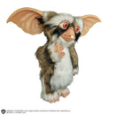 Gremlins 2: The New Batch Lenny Mogwai Prop Replica standing to the side with his right hand near his chest and lower chin and head tilted and eyes gazed