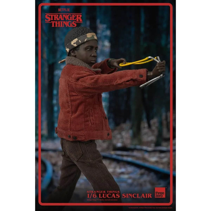 ThreeZero Lucas Sinclair Stranger Things Action Figure, 1/6 Scale, closeup using slingshot