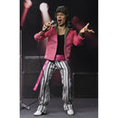 Action figure of Mick Jagger in a pink jacket and striped pants with a microphone, on a dark background.