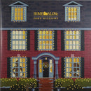 Cover of 'Home Alone' soundtrack album with house illustration and John Williams logo.