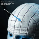 Close-up of a person's head with grid pattern, pin, and text instructions on a dark background.