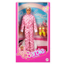 Barbie ken doll in pink pajamas with 'Barbieland' and 'Barbie The Movie' branding on packaging.
