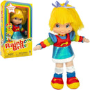 Rainbow Brite plush doll shown standing next to its retail box on a plain white background. The doll has bright yellow hair with a blue bow, a red and blue outfit with rainbow-colored arm bands, white socks, and red and yellow shoes.