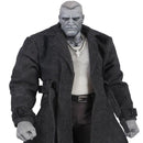 Action figure wearing a long coat on a white background