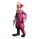 Colorful clown figurine with pink outfit and red hair on a white background