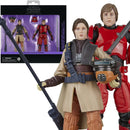 Two action figures in front of their packaging, with one figure in a beige outfit and the other in red.
