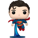 Superman figurine with red cape and blue suit on a white background