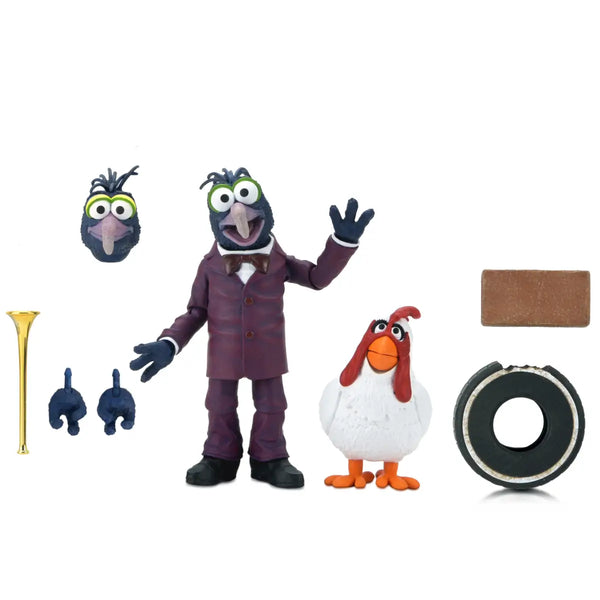 Muppet action figure set featuring Gonzo in a purple suit with interchangeable heads and hands, a white chicken figure, a gold horn, and accessories on a plain white background.