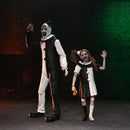 Two people in horror-themed costumes against a dark background