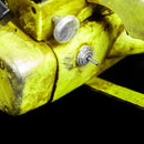 Close-up of a yellow metal bracket with screws on a black background