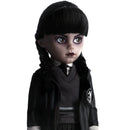 Wednesday Doll with dark hair styled in pigtails, wearing a black outfit with a white shirt underneath on a white background.