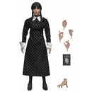 Wednesday Addams (Classic Dress) 8-Inch Clothed Action Figure standing next to Thing, a book, and additional hands