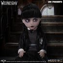 Wednesday Doll in a dark outfit with braided hair, sitting on steps with 'LDD Presents' and 'MEZCO TOYZ' branding.