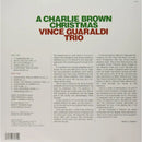 The back cover of the vinyl record album for 'A Charlie Brown Christmas' by Vince Guaraldi Trio, featuring tracklist, liner notes, and barcode on a light beige background.