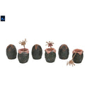 Set of six small decorative eggs with alien spider-like creatures on a white background