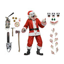 Action figure of a horror-themed Santa Claus with accessories on a white background