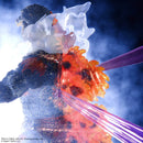 Close-up of Godzilla figure with fiery effects and a weapon against a dark background