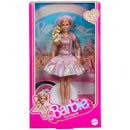Barbie doll in a pink dress with 'Barbie The Movie' packaging