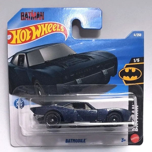 A Hot Wheels Batman Batmobile die-cast toy car in its original blister card packaging, featuring a dark blue car with a textured, weathered finish.