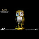 A vintage-stylized Bubo owl collectible figure from Star Ace's 6.5-inch DefoStyle series, featuring a metallic gold and silver body with blue and red eye details, standing on a gold base against a black background.